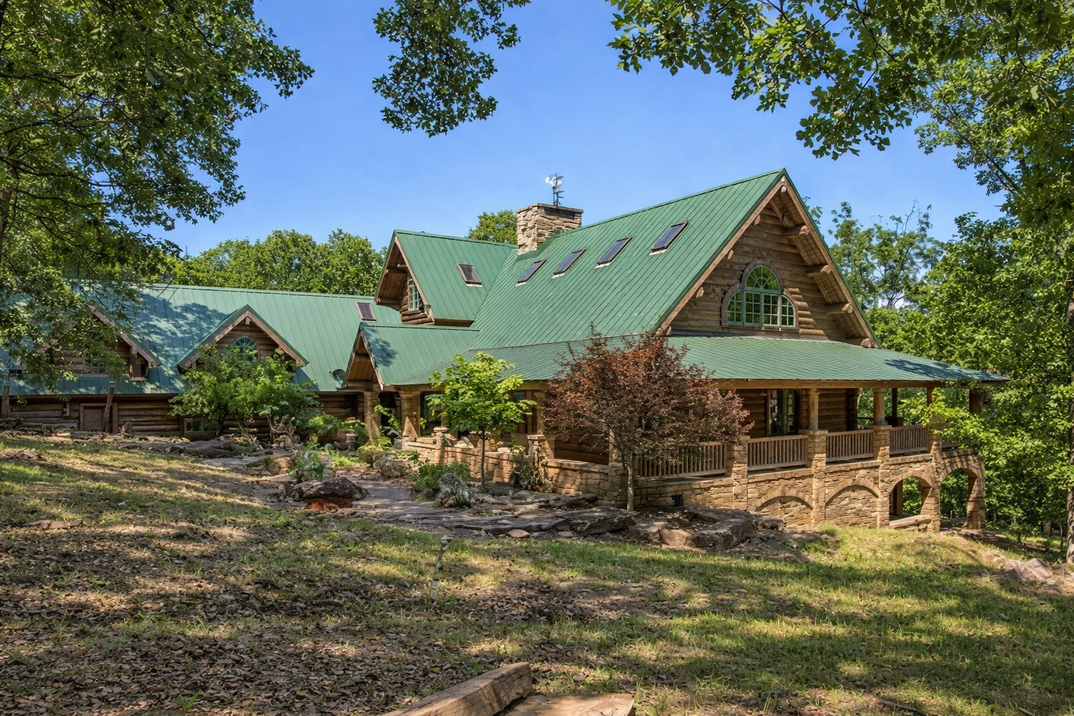 Custom 9,920 sq ft Log Lodge on 224 Acres with Riverfront, Guest Homes & Farm Structures