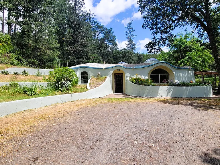 Unique Earth-Sheltered Home with Pond, Greenhouse and Private Acreage